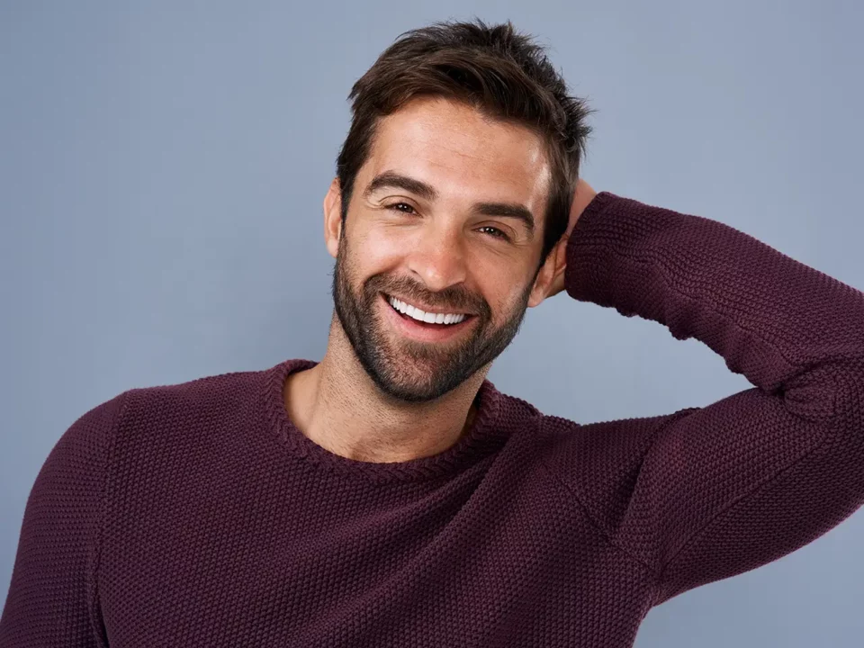Smiling man with a restored smile after dental implants